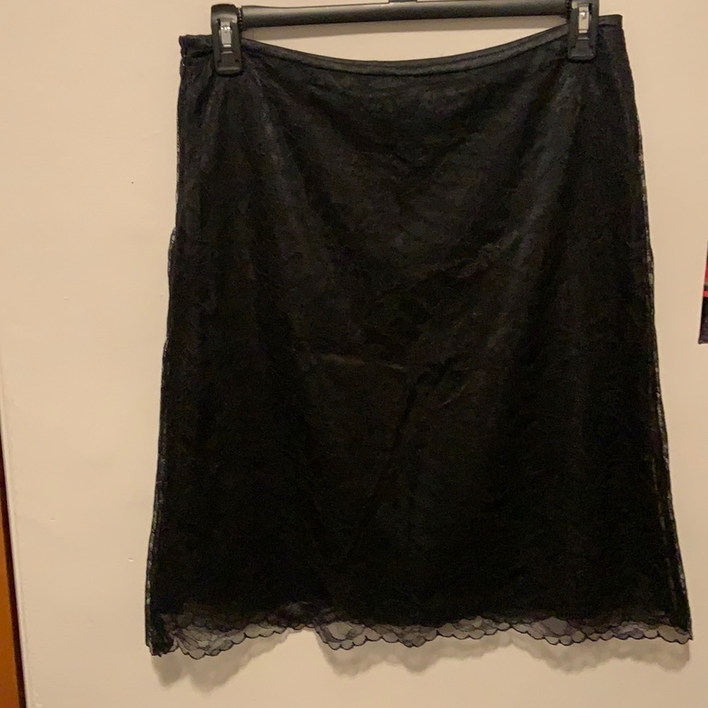 Black lace knee length skirt with zipper on side.